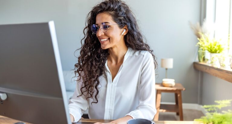 Shot of a young businesswoman working on a computer in an office. Portrait of an successful young creative businesswoman using PC at her workplace in the modern office